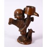 A JAPANESE BRONZE FIGURE OF A BOY & PIG, the boy holding an oil vessel aloft, signed underside,