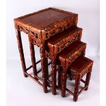 A FINE 19TH / 20TH CENTURY CHINESE CARVED HARD WOOD NEST OF FOUR DRAGON & BAT TABLES, the tops