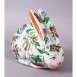 A 20TH CENTURY FAMILLE ROSE PORCELAIN HARE, painted with peach tree decoration, 12cm long.