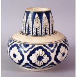 A SMALL ISLAMIC POTTERY VASE, of squat form painted with feather and flower motifs, 11cm high.