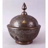 AN ISLAMIC CHASED AND ENGRAVED CIRCULAR BOWL AND COVER, partially inlaid with gold decorated with