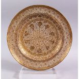 A GOOD INDIAN PIERCED GILDED WHITE METAL CIRCULAR DISH, 23cm diameter.