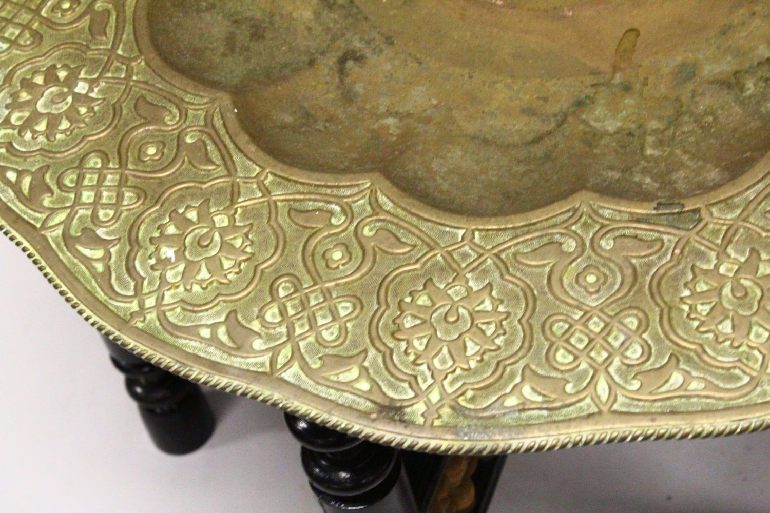 A GOOD LARGE ISLAMIC BRASS TRAY TABLE AND FOLDING STAND, with embossed decoration, 76cm diameter. - Image 3 of 3