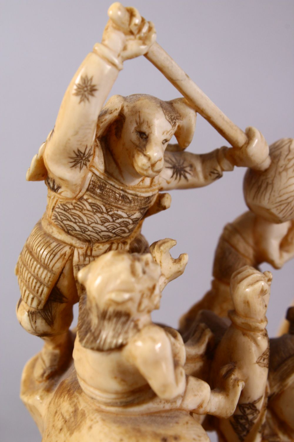 A JAPANESE MEIJI PERIOD CARVED IVORY OKIMONO GROUP - depicting figures attacking oni demons, one dog - Image 10 of 14