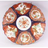 A JAPANESE IMARI CHARGER, with shaped edge, painted with six panels, alternatively painted with