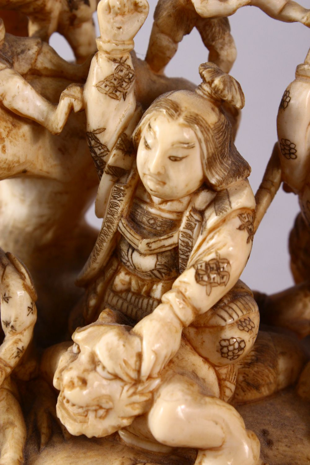 A JAPANESE MEIJI PERIOD CARVED IVORY OKIMONO GROUP - depicting figures attacking oni demons, one dog - Image 12 of 14