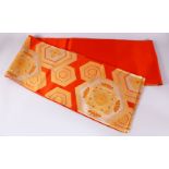 A FINE JAPANESE SILK EMBROIDERED FUKURO OBI TIE - upon an orange ground with silver and gold