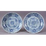 A PAIR OF 19TH CENTURY CHINESE BLUE AND WHITE CIRCULAR DISHES, painted with stylised flowerheads and