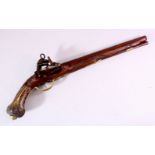 AN 18TH CENTURY INDIAN FLINTLOCK PISTOL, with silver inlaid barrel, well carved wooden stock with