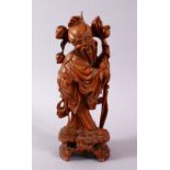 A 19TH CENTURY CARVED WOODEN FIGURE OF SHOU LAO, stood with his head tilted holding his staff and