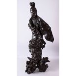 A LARGE ROOTWOOD CARVING OF GUANYIN, the base with naturalistic form, 102cm high, 38cm wide.