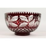 A LARGE BOHEMIAN RUBY TINTED CIRCULAR BOWL, engraved with pineapples and other fruit. 9.5ins