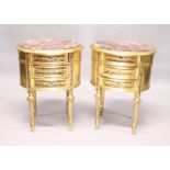A PAIR OF GILTWOOD OVAL BEDSIDE TABLES with marble tops and three drawers.