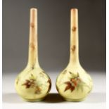 A SMALL PAIR OF BURMESE BULBOUS VASES painted with flowers. 7.5ins high.