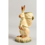 A RARE ROYAL WORCESTER FIGURE OF BR'ER RABBIT carrying a wicker basket on his back, date code 1916.