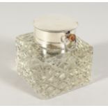 A SILVER AND CUT GLASS SQUARE INKSTAND, the top inset with a watch. 4ins square. London 1903.