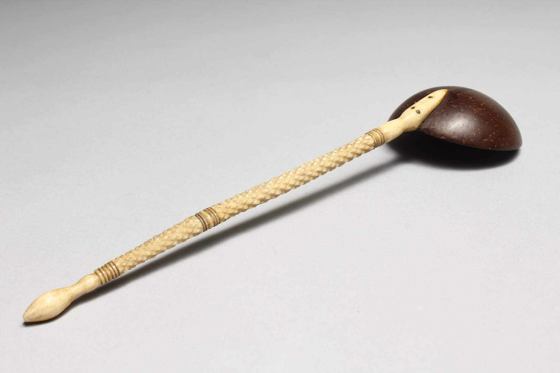 A NATIVE NUT BOWL SPOON with carved ivory handle. 10ins long. - Image 2 of 4