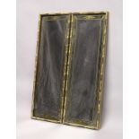 A PAIR OF EGLOMISE LONG MIRRORS with bamboo type frame. 3ft long x 1ft wide.