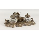 A VICTORIAN METAL INKSTAND OF RUSTIC DESIGN, with two glass inkwells and a horse. 9.5ins wide.