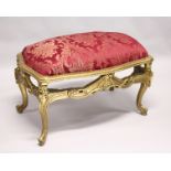 A LARGE GILTWOOD STOOL with red padded top. 3ft 3ins long.