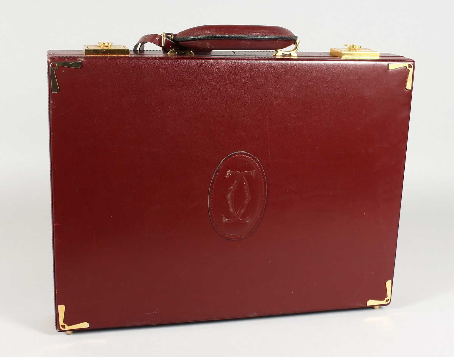 A VERY GOOD CARTIER MAROON BRIEFCASE.