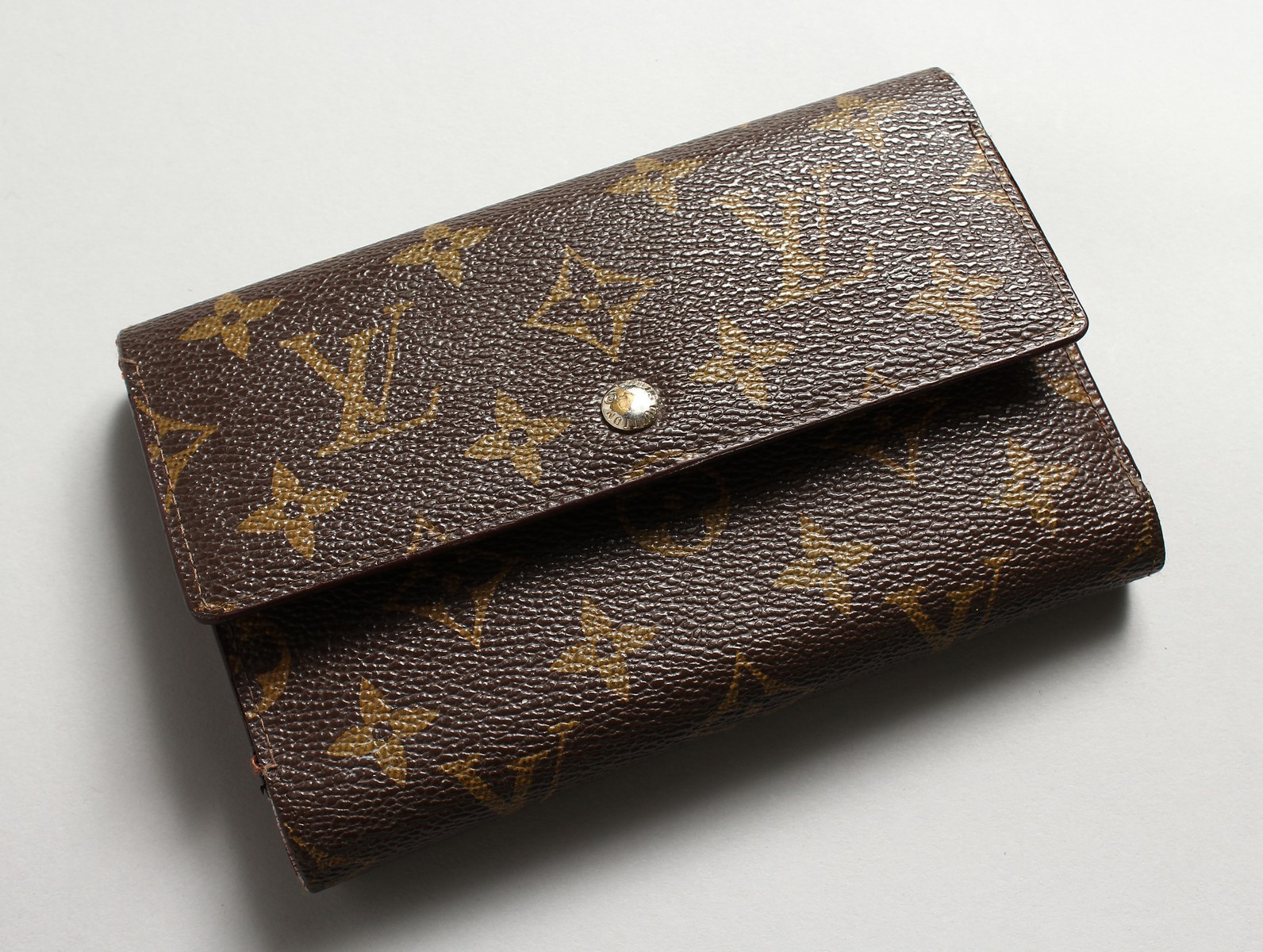 A LOUIS VUITTON STYLE MONOGRAM WALLET.