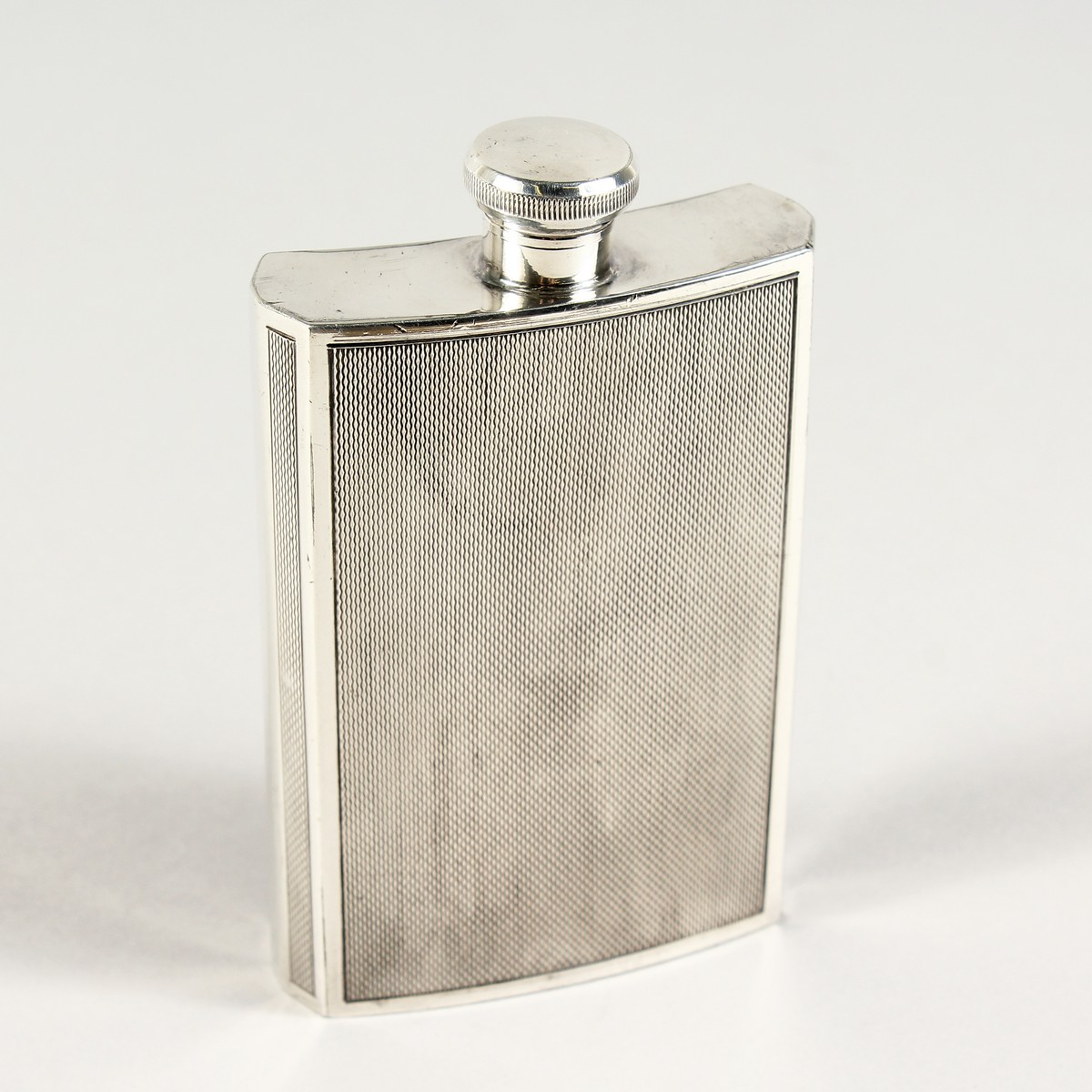 A WALKER & HALL ENGINE TURNED E.P.N.S. WHISKY FLASK.