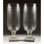 A PAIR OF CUT GLASS STORM LAMPS on square bases. 16ins high.