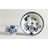 AN 18TH CENTURY LIVERPOOL BLUE AND WHITE TEA BOWL AND SAUCER with bird on a branch.