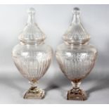 A GOOD LARGE PAIR OF CRYSTAL CUT SWEET JARS AND COVERS on square stepped bases. 21ins high.