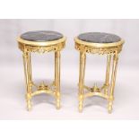 A PAIR OF GILTWOOD CIRCULAR TABLES with marble tops.