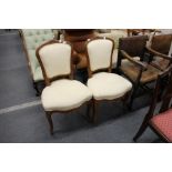 A pair of French style beech framed and upholstered dining chairs.