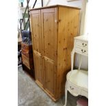 A modern pine two door linen cupboard.