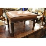 A George III style leather upholstered stool.