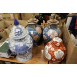 A pair of Chinese lamps, a ginger jar and cover and a blue and white jar and cover.