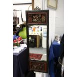 A Chinese mirror with carved wood and lacquered frame.