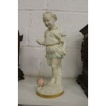 An unusual Worcester part glazed Parian figure of a young girl kicking a ball.