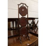 A mahogany three tier folding cake stand.