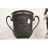 A Royal Doulton black basalt Charles Dickens commemorative twin handled urn.