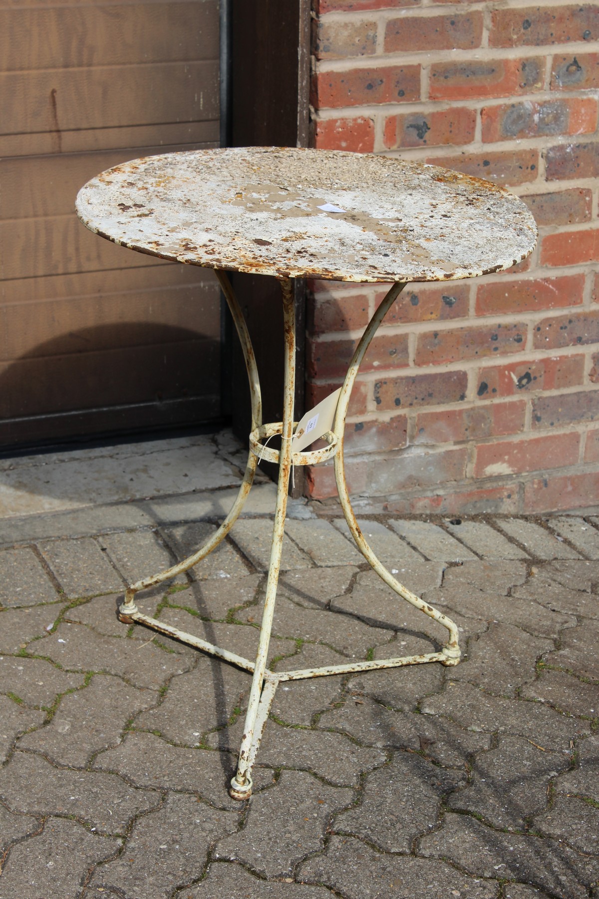 A small white painted wrought iron bistro table.