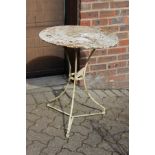 A small white painted wrought iron bistro table.