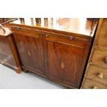 A 19th century mahogany two door cupboard with brushing slide.