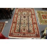 A modern Persian rug, beige ground with allover floral decoration.