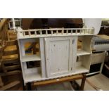 A painted single door hanging shelf unit.