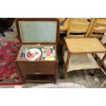 An oak sewing trolley with numerous sewing items including threads, patterns, a large quantity of