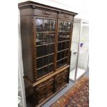 A large oak bookcase with cupboard base.