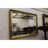 A decorative gilt framed wall mirror.