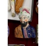 A Staffordshire spill vase modelled as a bust of a Turkish man.