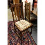 A set of four oak dining chairs.