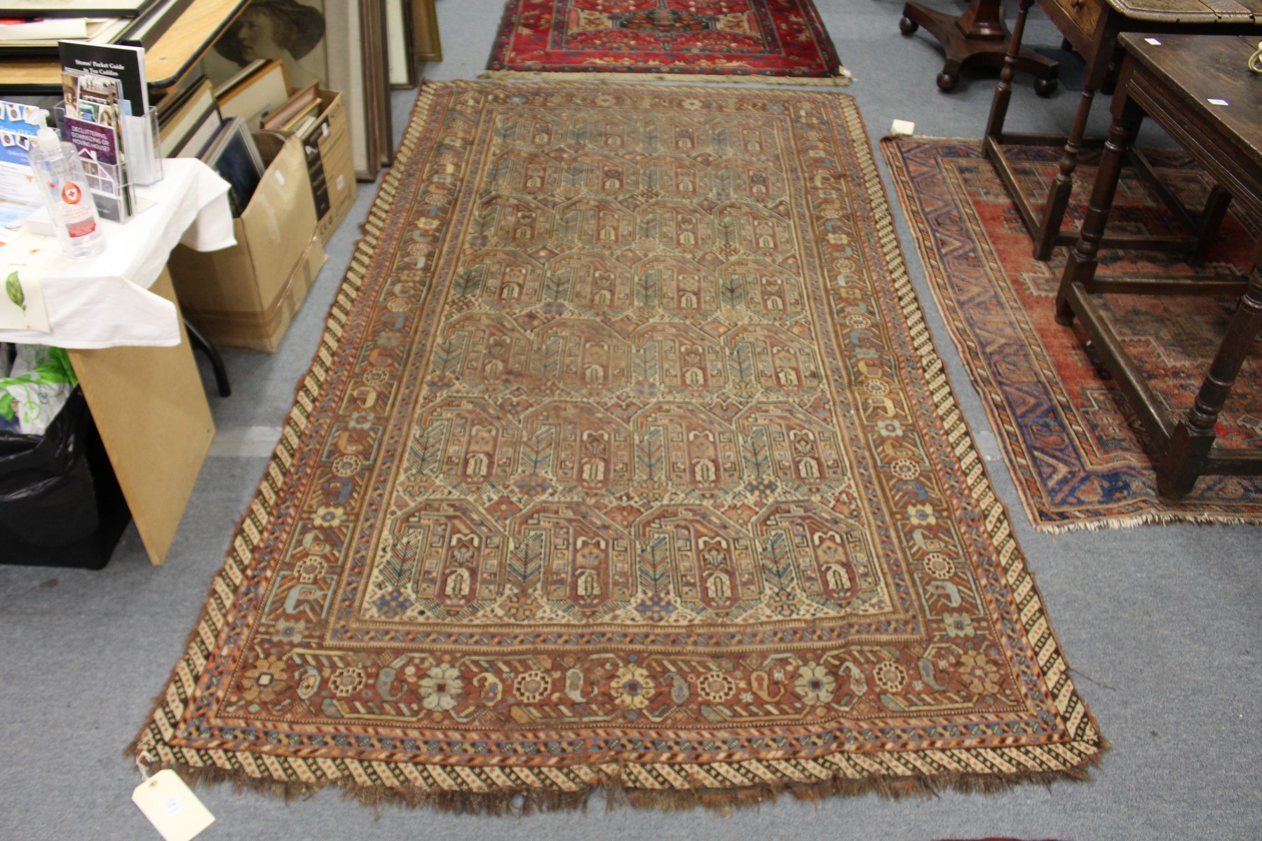 An unusual Persian rug, rust ground with large stylized boteh decoration.